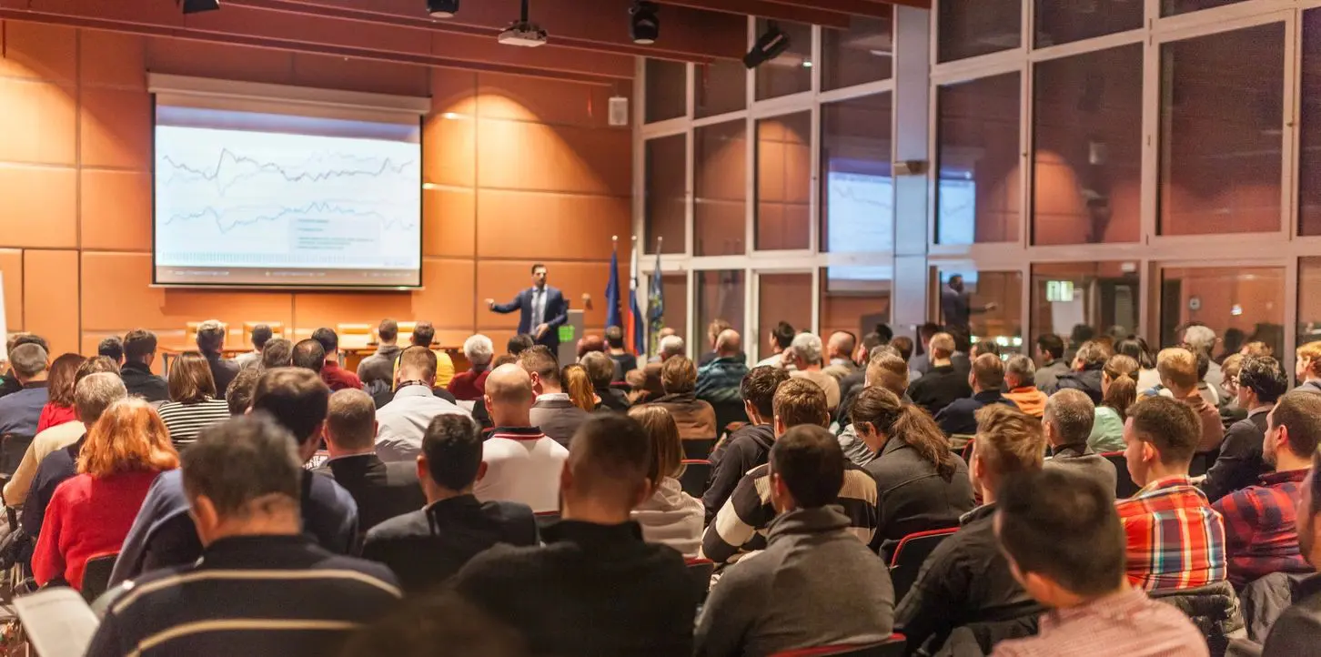 A large group of people in an auditorium.